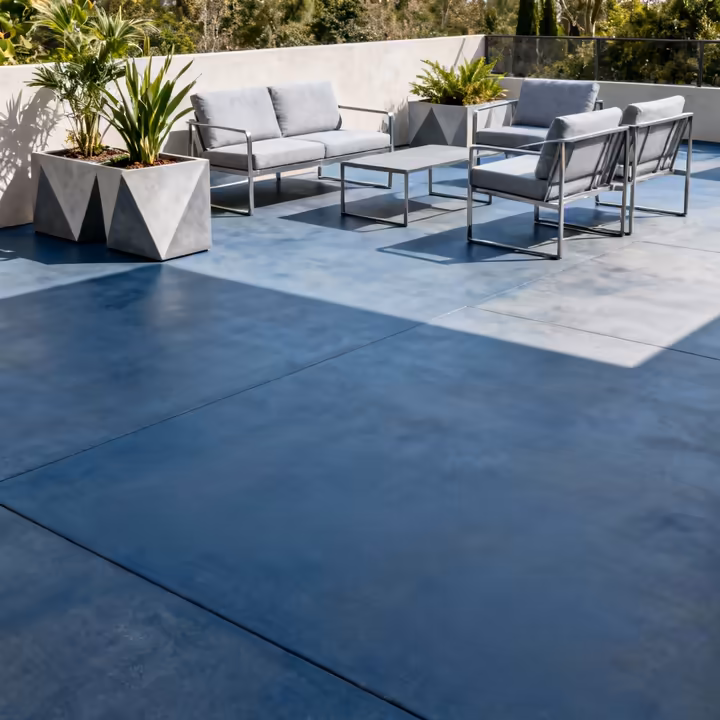 An outdoor patio with a concrete floor stained a vibrant and uniform slate blue color using a water-based stain.